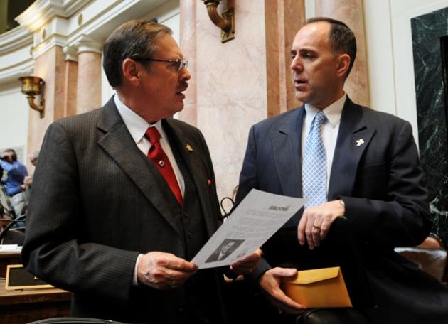 (Left) Rep. C.B. Embry, Jr., R-Morgantown (17th District) talks with Rep. Tim Moore, R-Elizabethtown (26th District) on the floor of the Kentucky House of Representatives during the first day of the 2014 Regular Session. (Photo: LRC Public Information)
