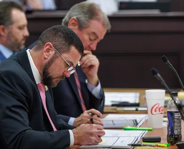 House Speaker Pro Tempore David Meade, R-Stanford, (foreground) looks over documents as a conference committee on the new state budget begins deliberations Friday. 