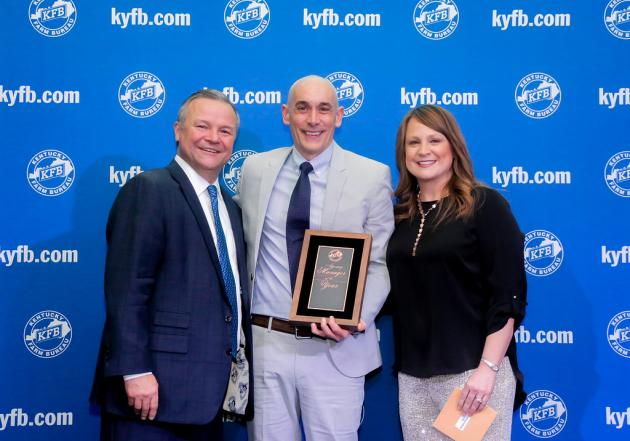 Chuck Osborne, KFB Insurance Vice President of Agency Support & Marketing (left), and Jessica Sullivan, KFB Insurance Agency Support & Marketing Manager for District Two (right), present James Runion (center) with the 2019 District Two Agency Manager of the Year Award.   