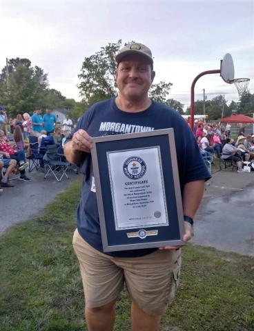 Mayor Billy Phelps holds the official certificate for the city's new Guinness World Record