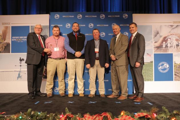 Butler County Farm Bureau receives 2018 Young Farmer Gold Star Award of Excellence.  Pictured from left: Kentucky Farm Bureau President Mark Haney, Butler County Young Farmer Co-Chairs Joe Kirby and Caleb Smithson, County President Shane Wells, Kentucky Farm Bureau Federation Executive Vice President Drew Graham and Executive Vice President and CEO of Kentucky Farm Bureau Insurance John Sparrow.  The award was presented during a November 30 recognition program at the 99th Kentucky Farm Bureau annual meeting