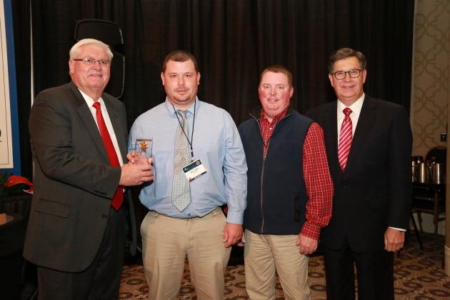 Joe Kirby, Young Farmer Chair for Butler County Farm Bureau (center left), accepts the Gold Star Award of Excellence from Mark Haney, Kentucky Farm Bureau President (far left). Also pictured are Shane Wells, President of Butler  County Farm Bureau (center right) and David S. Beck, Kentucky Farm Bureau Executive Vice President (far right).