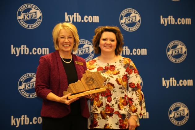   Sherri Kirby of the Butler County Farm Bureau Women’s Committee, accept the 2018 Gold Star Award of Excellence from Vicki Bryant, chair of the Kentucky Farm Bureau state Women’s Committee. The award was presented during a November 30 recognition program at the 99th Kentucky Farm Bureau annual meeting.