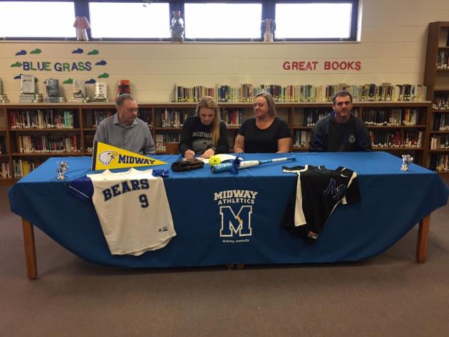 Cheyenn White signs her letter-of-intent as family members look on.  