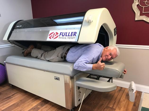 Butler County Judge Executive David Fields tries out one of the Fuller Physical Therapy aqua massage machines.