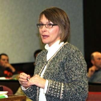 Gina Tynes, of Hocker Family Insurance, speaks to magistrates.  (file photo).  Tynes joined Rob Brown of KACO in presenting Fiscal Court a $7,196.07 dividend check for Worker's Comp.