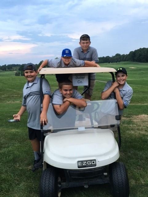 The boys literally hanging onto Coach Moore's cart.