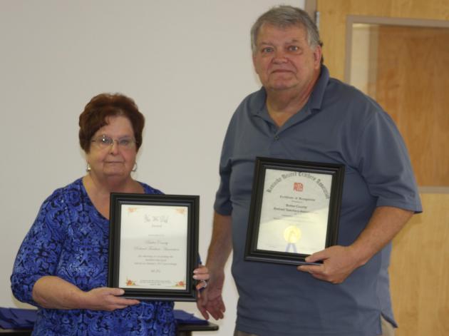 Sue Embry and Fred Tate display the "Yes We Did Award" and the "Gold Star Award."