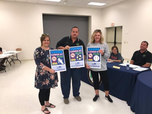 Butler County Drug-Free Coalition employees Rhonda Vaughn and Ali Johnson presented Mayor Phelps with new signs for the park that say, “Young lungs at play. This is a smoke free zone.”