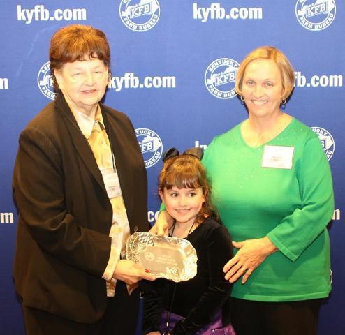Rita Drake, chair of the BC Farm Bureau Women’s Committee (right) and granddaughter Maggie Drake, accepts the 2013 Gold Star Award of Excellence from Phyllis Amyx, chair of the KYFB state Women’s Committee (left). 