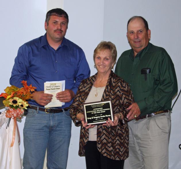 Chad Johnson presents Rita and Greg Drake with Outstanding Agriculture Business Award.