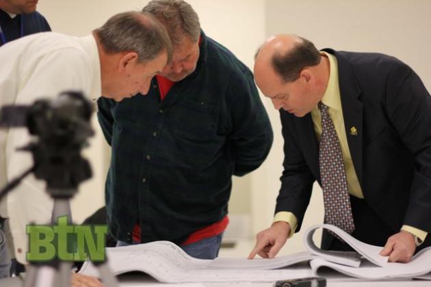 Councilman Gary Southerland, Gigi Rose, and Greg Meredith look over plans.