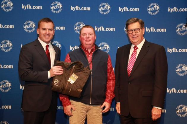 Shane Wells, President of Butler County Farm Bureau (center), accepts the award from John Sparrow, Chief Executive Officer of KFB Insurance Companies (left), and David S. Beck, Executive Vice President of the KFB Federation (right), during a December 2 recognition and awards program.