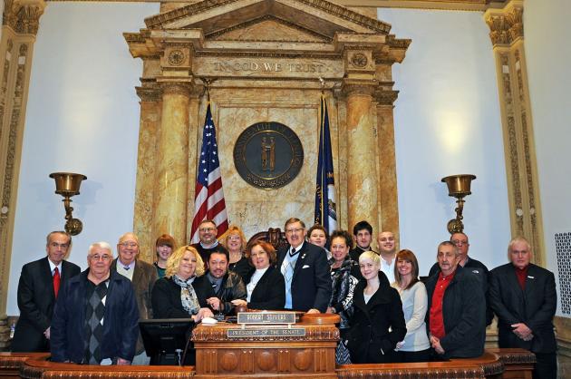 Senator C.B. Embry (R-Morgantown) welcomes guests to the Senate Chamber. Pictured from Right to Left are Secretary of Public Protection Cabinet Ambrose Wilson, IV, Lonnie Hawes, Joe D. Forgy, April West, Darlene Embry, Todd Zuehl, C.B. Embry, III, Laura Ann Zuehl, Wanda Lou Embry, Senator C.B. Embry, Jr., Jacob Zuehl, Barbara Ann Embry, Dale West, Meredith Embry, C.B. Embry, IV, Jamie McDaniel, Ohio County Magistrate Larry Morphew, Brandon Morphew, and Hartford Mayor Dean Minton.