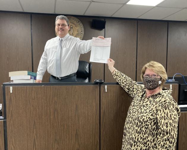 Butler County Clerk Sherry Johnson presents $239,968.48 check to Judge Tim Flener