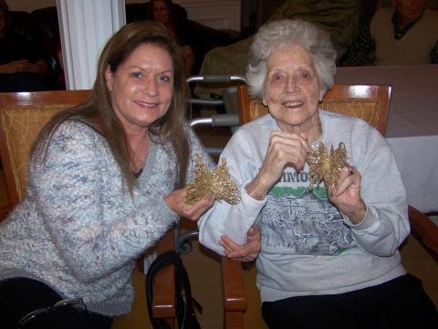 Resident Kate Gerow and daughter, Carla Gerow, show off their ornaments that will be placed on the MCRC Christmas tree during the Tree Lighting ceremony.