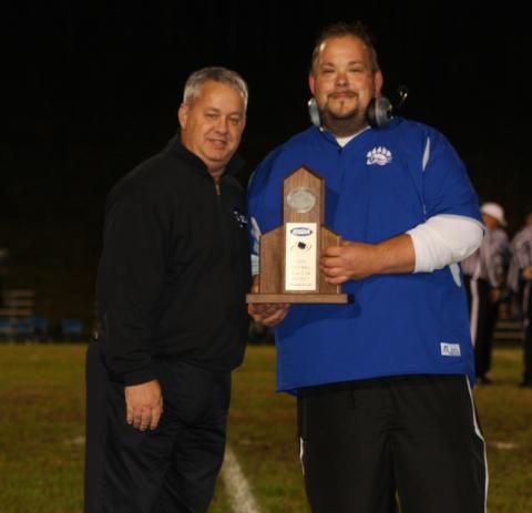 Supt. Scott Howard presented Coach Emmick with the district runner-up trophy.
