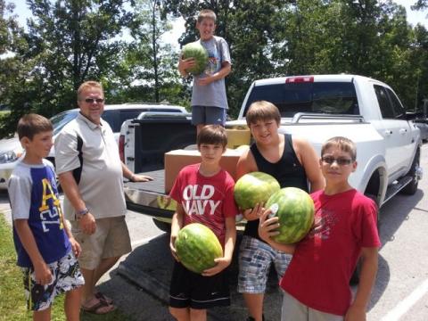 Morgantown City Council member Terrell House helps unload watermelons from the Boys and Girls Club. 