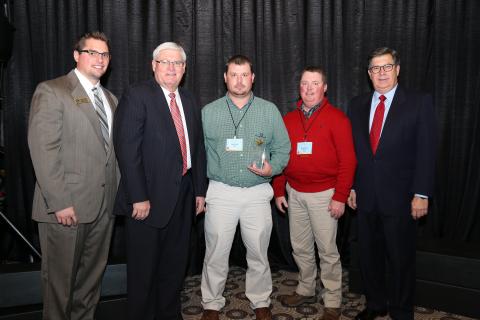  Joey Kirby, Young Farmer Chair for Butler County Farm Bureau (center), accepts the Gold Star Award of Excellence from Mark Haney, Kentucky Farm Bureau President (center left). Also pictured are Shane Wells, President of Butler  County Farm Bureau (center right), Jackson Tolle, Assistant Director, Agricultural Education, Women and Young Farmer Programs (far left), and David S. Beck, Kentucky Farm Bureau Executive Vice President (far right). 
