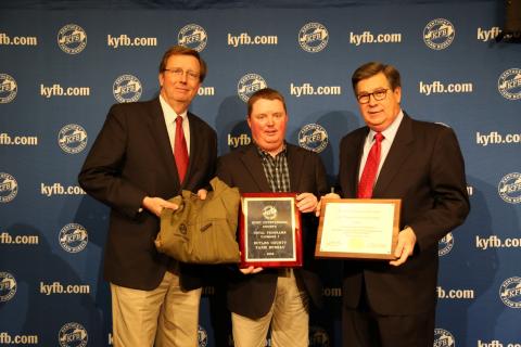  Shane Wells, President of Butler County Farm Bureau (center), accepts the award from Brad Smith, Chief Executive Officer of KFB Insurance Companies (left), and David S. Beck, Executive Vice President of the KFB Federation (right), during a December 4 recognition and awards program.