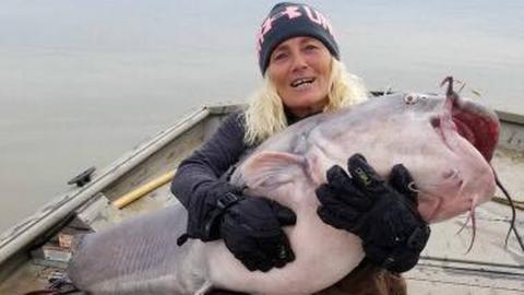 Caption: Paula Cathey Smith caught an 88-pound catfish Sunday. on Kentucky Lake. TENNESSEE WILDLIFE RESOURCES AGENCY