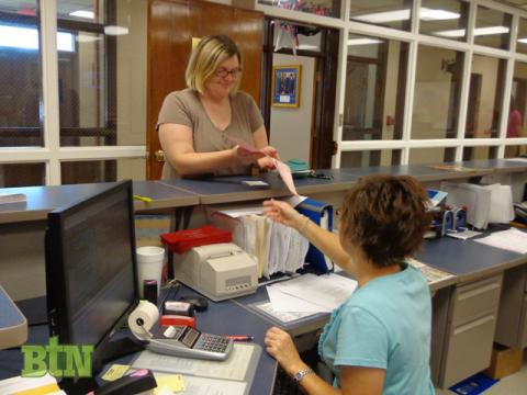 Merritt gets her copy of the registration forms back