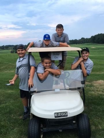 The boys literally hanging onto Coach Moore's cart.