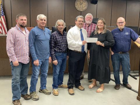 Court presenting Heather Stockstill of BRACAC with a donation.