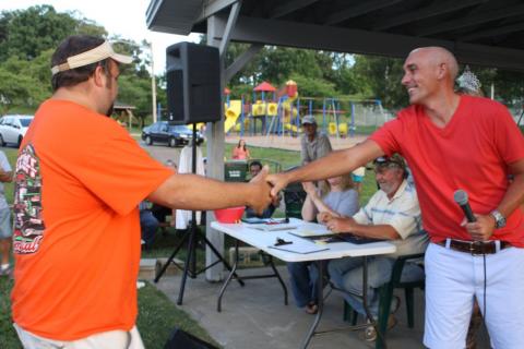 Chamber President James Runion congratulates Joey Summers on catching the largest catfish of the tournament.  Summers was also the top money prize winner at $2,100.