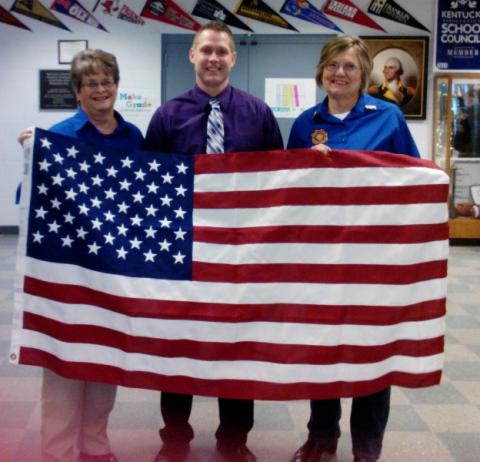 Jennifer Odle and Lynda Knight presents BCMS Principal Robert Tuck with a new flag.
