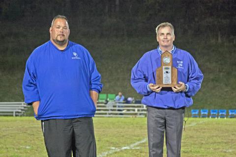 BCHS Principal Michael Gruber presents BCHS football head coach Ryan Emmick with a district runner-up trophy