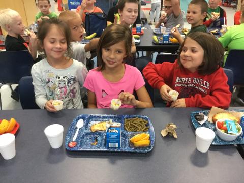 NBES students enjoy food from their garden.