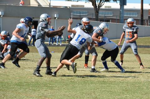 Pablo Cedillo (#51) and Mathew Jones (#18) go in for the tackle