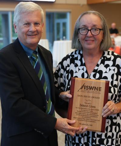 ISWNE Executive Director Chad Stebbins presents the Don Brod Award to Dr. Deborah T. Givens.