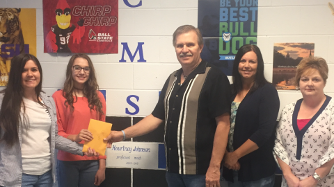 8th graders Rayna Beller and Reagan West present $688 to Garry McKinney of the Morgantown Mission for the backpack program.  Also pictured are Karla Coles and Angie Burden with the B.C. Family Resource Center