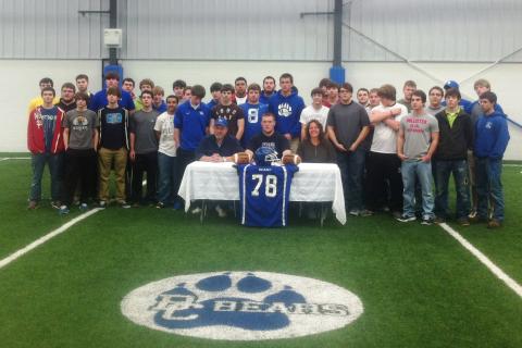 Senior football player Ricky Palmer is joined by family, friends and teammates as he signs to play football at Kentucky Wesleyan.