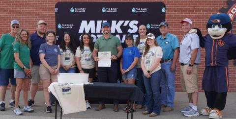 Commissioner of Agriculture Jonathan Shell, center, was joined by dairy industry representatives and dairy producers on Tuesday, June 3, to sign a proclamation honoring the dairy industry and June as Dairy Month in Kentucky. The proclamation was signed during Dairy Night at the Ballgame with the Bowling Green Hot Rods.