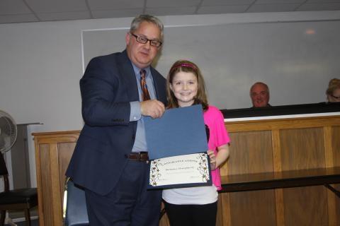Delaney Daugherty, a fifth grader at North Butler Elementary, was recognized at the meeting for winning the 2016 AARP Grandparent Essay Contest. 