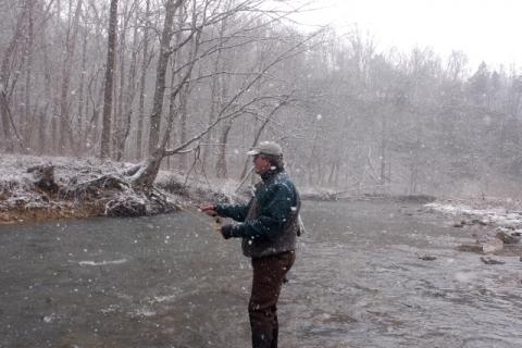 Dave Baker, editor of Kentucky Afield magazine, casts a fly in Otter Creek in Meade County for trout during a snow shower. Otter Creek is one of the 13 seasonal catch and release trout streams across Kentucky that offers quality trout fishing all winter long.   