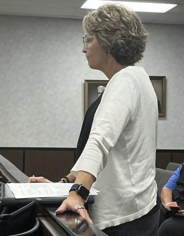 Gina Tynes presenting insurance costs.