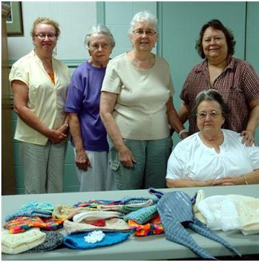 Members of Butler County Knitters and Crocheters displaying their work.