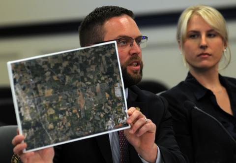 Rep. Michael Meredith, R-Oakland, displaying a map of the Kentucky-Tennessee border. Meredith, who serves on the committee, said he and others are looking at where Kentucky stands regarding local taxation and how the state measures up with other entities across the nation. Looking on is Lena Muldoon, executive director of You Decide, Kentucky!   