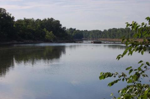 A reflection of the Skilesville skyline (left) overlooking Rochester Dam number 3 as seen from the Rochester boat launch