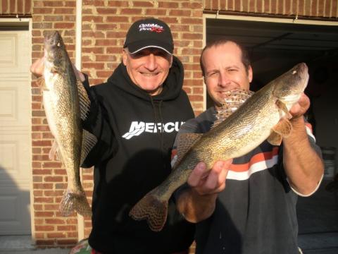 Ryan Oster (right) and his father Joe, (left) hold two sauger measuring about 18 inches caught from below Lock and Dam 6 on the Kentucky River in central Kentucky.