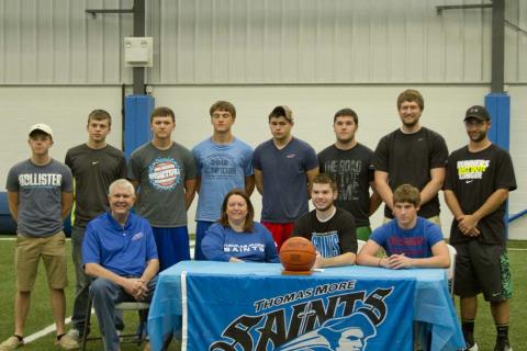 Zeke Woodcock with his parents, Greg and Teresa, and his teammates.