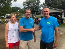 Deneatra and Cody Henderson of Henderson Land Surveying congratulate fisherman Kendall Embry, who caught the $500 catfish they sponsored. 