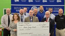 Supt. Robert Tuck symbolically accepts General Assembly funding from State Rep. Rebecca Raymer and State Senator Stephen Meredith.  They are joined by BCHS Principal Stoye Young, BCMS Principal Tim Freeman, NBE Principal Ben WIlson, BCLC Principal Josh Derque, Director of Transportation and Facility Operations Ryan Emmick, MES Principal Hunter Gary, and Asst. Supt. Josh Belcher 