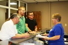 Roger Givens, Cody Donaldson, and Josh Hampton turn in the petition to County Court Clerk Sherry Johnson