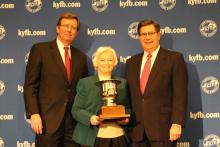 Betty Farris, President of Butler County Farm Bureau (center), accepts the “Top County” award from David S. Beck, KFB Executive Vice President (right), and Bradley R. Smith, KFB Insurance Companies Chief Executive Officer (left).