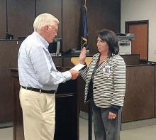 Judge David Fields administers the oath of office to Teresa Johnson.